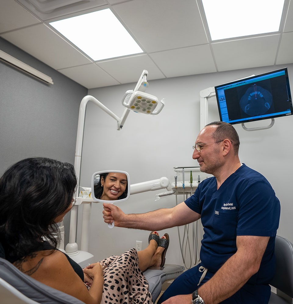 Doctor holding a mirror in front of a patient
